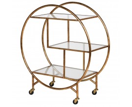 Dizajnový vintage regál Samira na kolieskach okrúhleho tvaru s tromi sklenými policami s kovovou konštrukciou v zlatej farbe s patinou